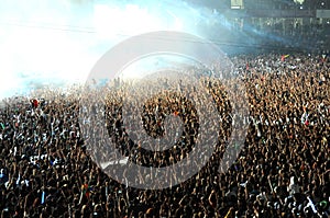 Crowd of people raising their hands at a concert